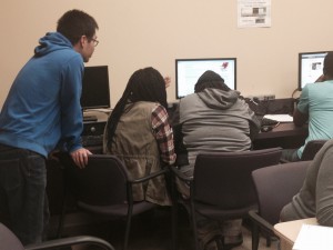 Hansen Pei of Temple University helps tutor a PSIP participant with his colleague.